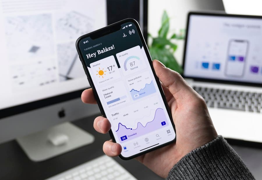Hand holding a phone showing a mobile application dashboard